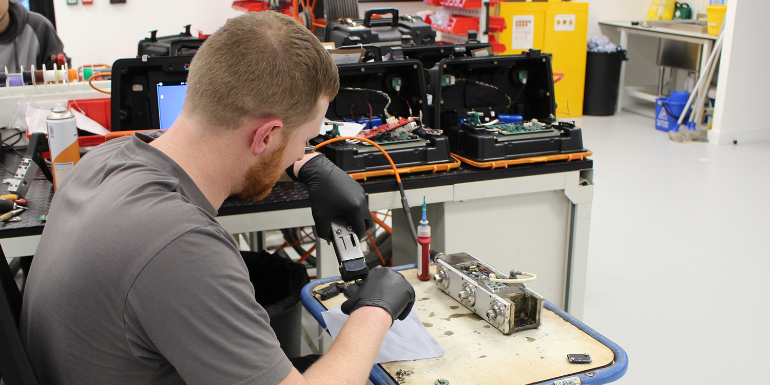 Service technician performing a repair on a crawler